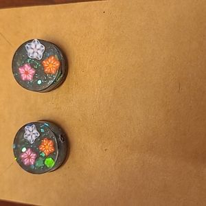 Glittery flowers in space stud earrings
